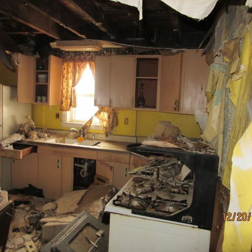 A kitchen with deteriorating cabinets