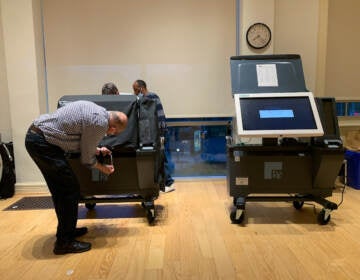 election worker fixing a voting machine