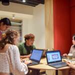 Members of Feeding Philly, a Central High School student club focused on combating hunger, work on their website in advance of the start of the academic year. (Ella Lathan for Billy Penn)