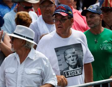 Trump supporter wearing a shirt with a fake Trump mugshot on it