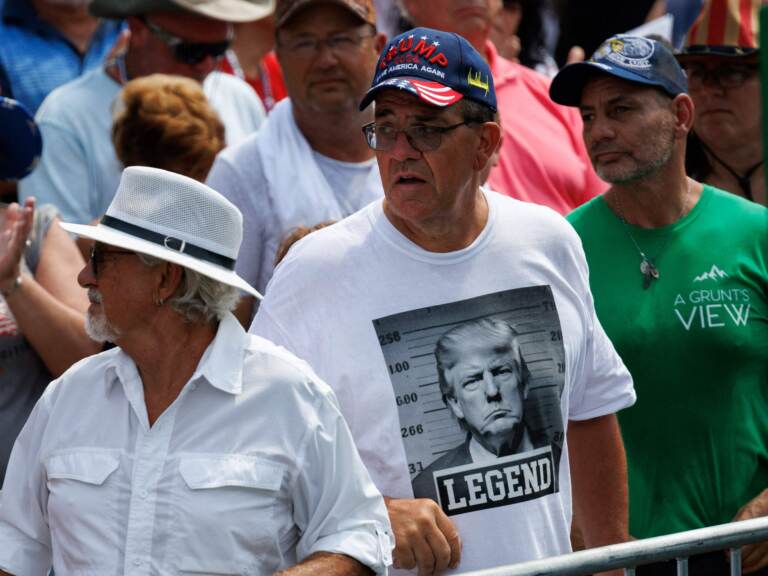 Trump supporter wearing a shirt with a fake Trump mugshot on it