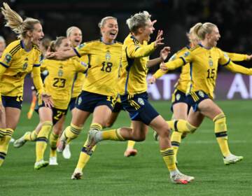 Sweden's forward #08 Lina Hurtig (C) and teammates celebrate their win following a penalty kick shootout over two-time defending champion U.S. at the Women's World Cup. It was the U.S.'s earliest exit from the tournament.