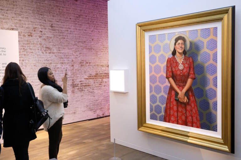 Attendees gaze at a painting of Henrietta Lacks by Kadir Nelson at HBO's The HeLa Project Exhibit for The Immortal Life of Henrietta Lacks in 2017 in New York City. Nicholas Hunt/Getty Images for HBO