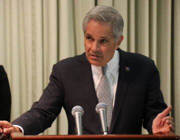 DA Krasner speaks at a podium.