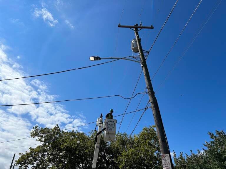 A contractor installs an LED street light