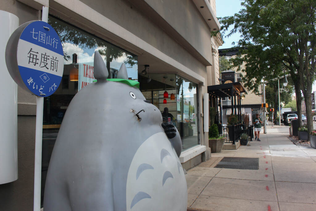 A statue of Totoro greets visitors outside the front entrance