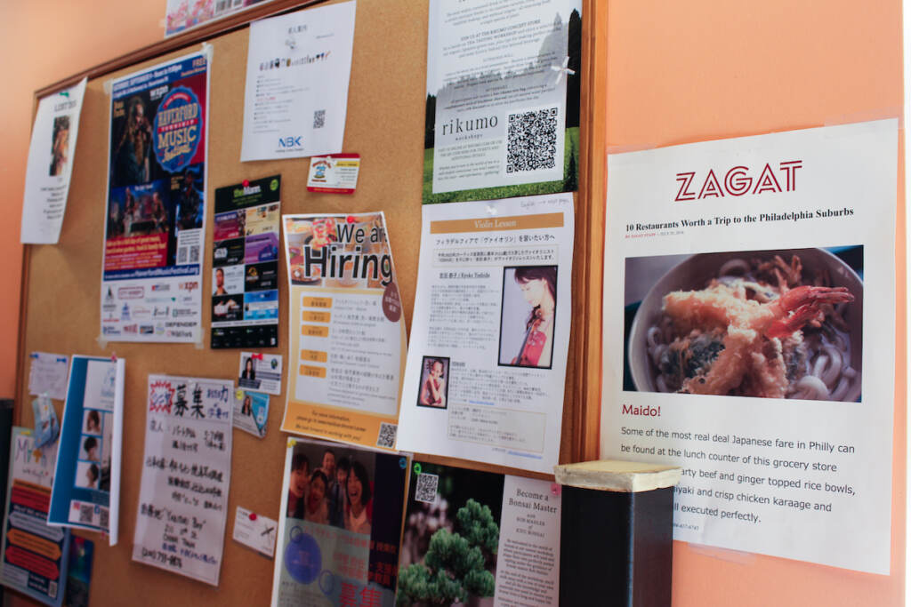 A bulletin board displays local advertisements and classifieds in English and Japanese
