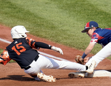 Smithfield, R.I.'s Brayden Castellone (15) slides safely into third base under the tag of Media, Pa.'s Patrick Diedrich