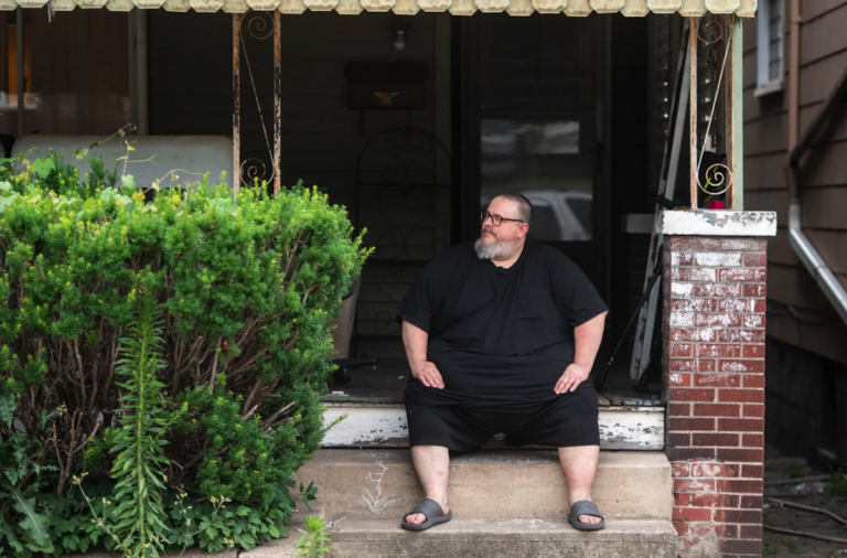 Mike Ramsey in front of his house.