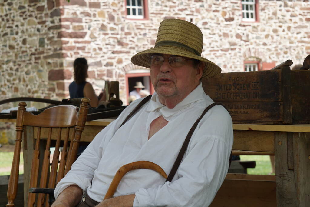 Alan Keyser looks on, wearing traditional Pennsylvania Dutch attire