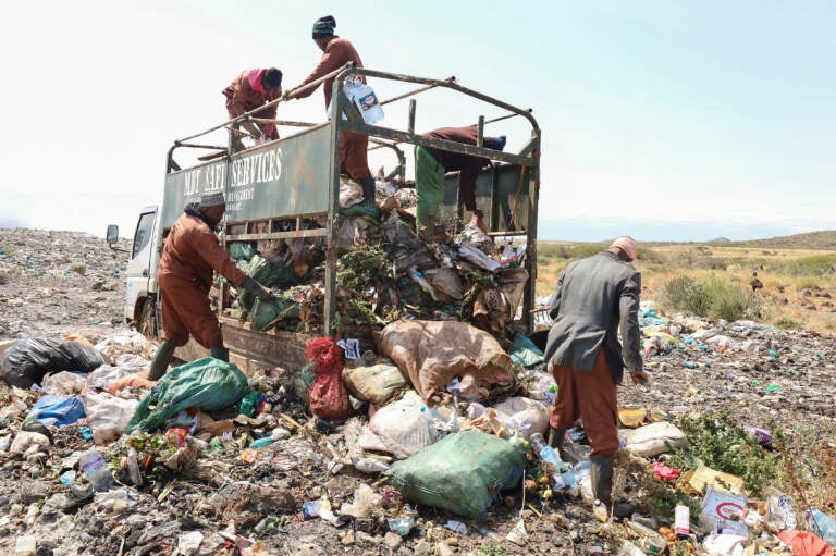 Trash collectors from Marsabit Safi Services offload waste at the Dadach Boshe dump. Even though Kenyan banned single-use plastic bags in 2016, they're still piling up at the dump and blowing off to litter the landscape and bodies of water.