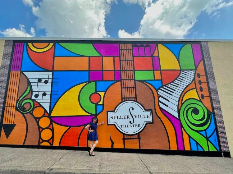 sellersville-5 Elayne Brick poses in front of a mural with many colors that shows a guitar, keyboards, and the words