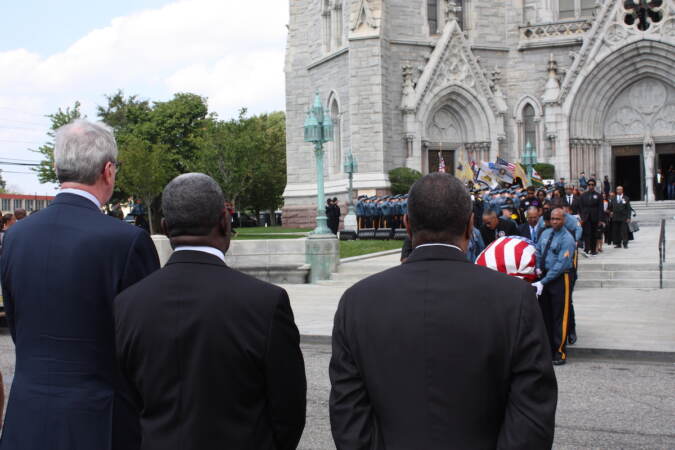 N.J. Gov. Phil Murphy (left) looks on as the casket of Lt. Gov. Sheila OIiver is carried from the Cathedral Basilica of the Sacred Heart to a hearse in Newark, N.J. (P. Kenneth Burns/WHYY)