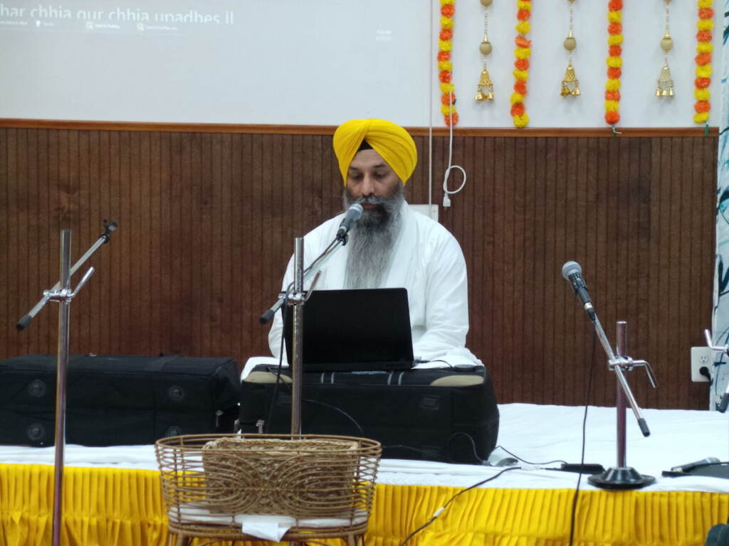 Head Priest Giani Gurjit Singh reciting hymns from the Sikh Holy Scripture
