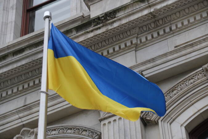 Ukraine's flag with a blue stripe above a gold stripe flies on a flagpole outside of Philadelphia City Hall