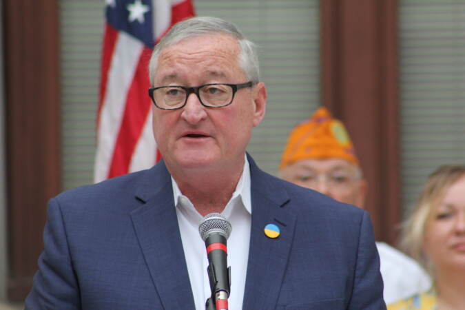 Mayor Jim Kenney speaks into a microphone.