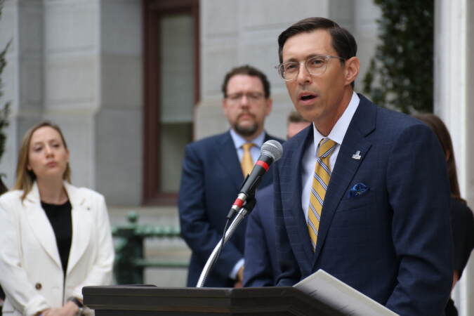 Manor College President Jonathan Peri speaks into a microphone