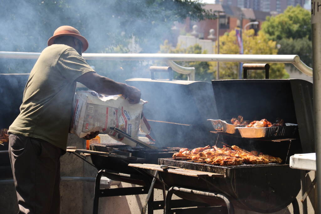 A vendor preps another grill as another one is going at Brazilian Day Philadelphia on Sunday