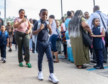 Parents walking their children to school