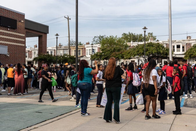 Parents and students line up in front of the school