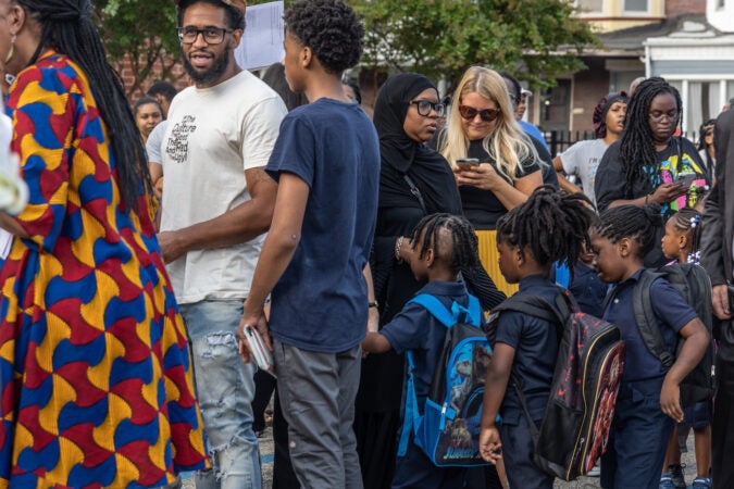 Parents and students line up in front of the school