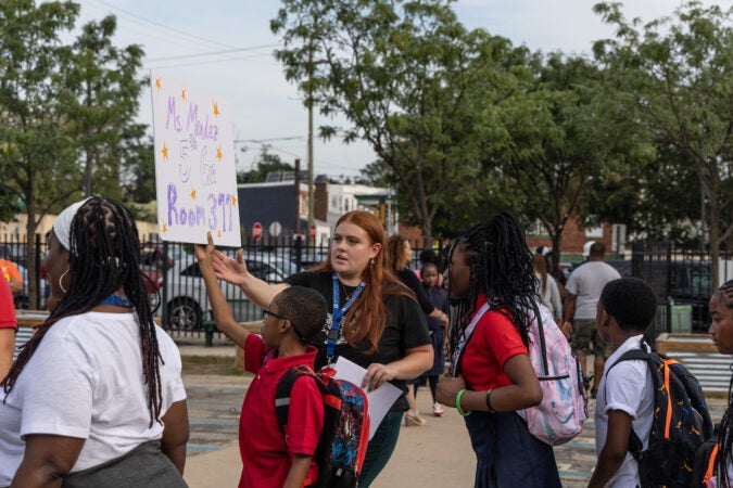 Students gather in front of the school