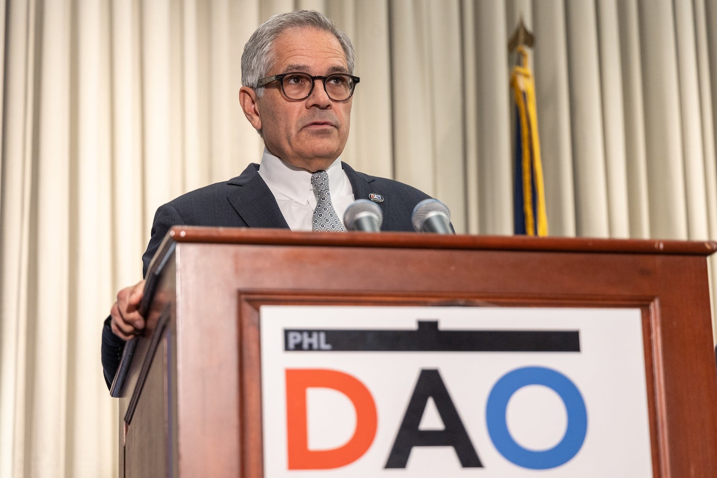 Larry Krasner speaking at a podium