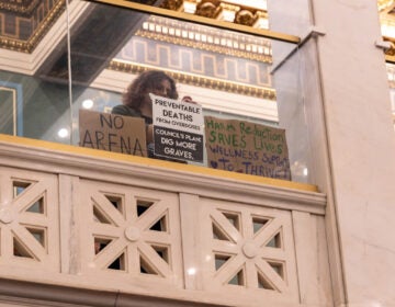 Protesters of a bill that would ban supervised injection sites displayed signs in the gallery of Philadelphia council chambers on Sept. 14, 2023. (Kimberly Paynter/WHYY)