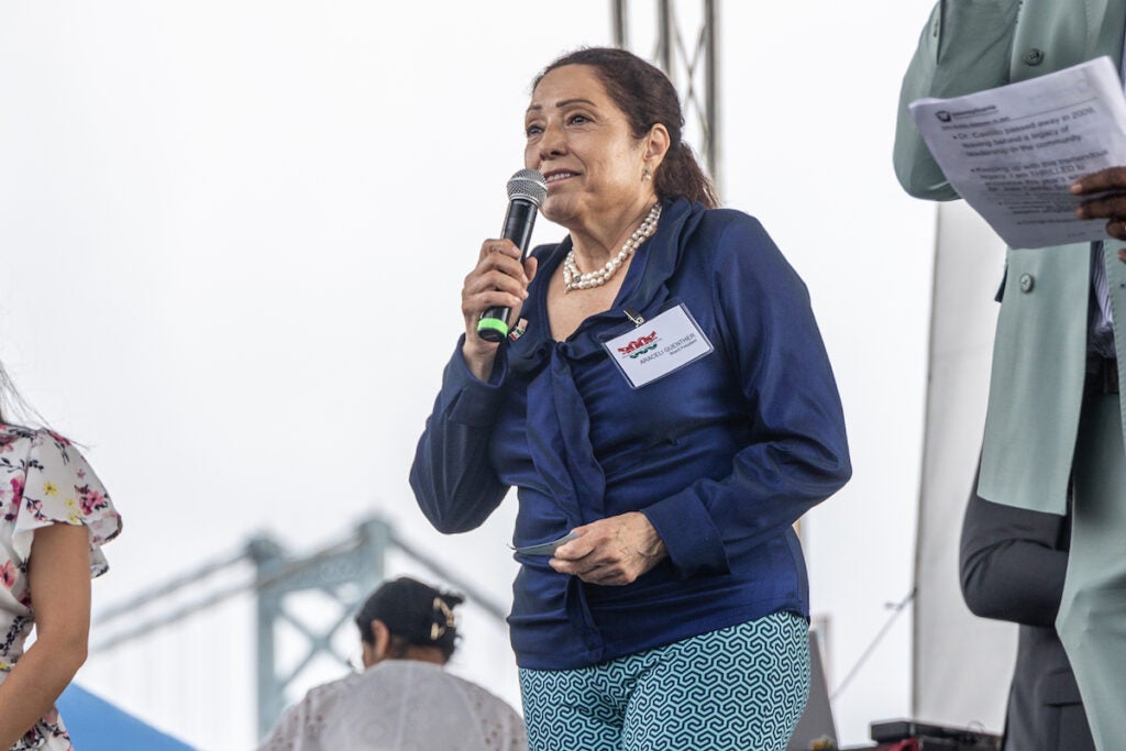 Araceli Guenther speaks into a microphone.