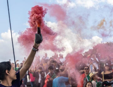 Mexican Cultural Center staff released colored smoke during the El Grito de Dolores ceremony