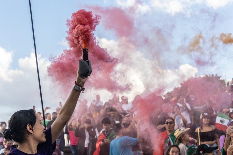 Mexican Cultural Center staff released colored smoke during the El Grito de Dolores ceremony