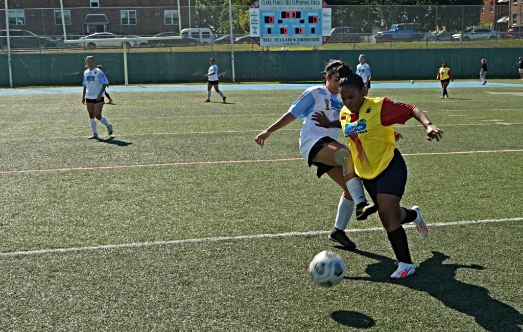 Players from Colombia and Argentina jostle for possession of the soccer ball