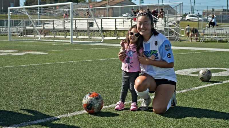 A young fan poses with a member of the Argentina Unity Cup team