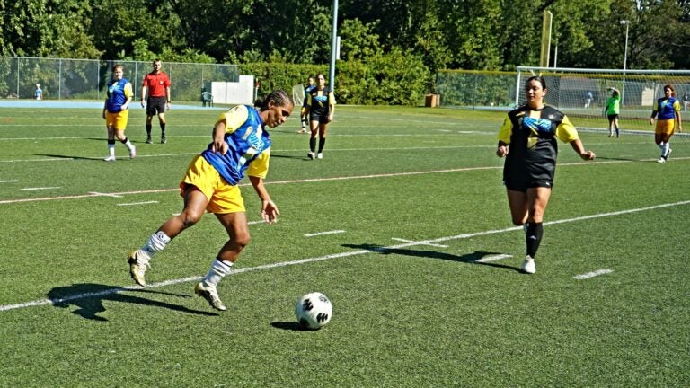 A member of the Brazil women's team kicks a soccer ball