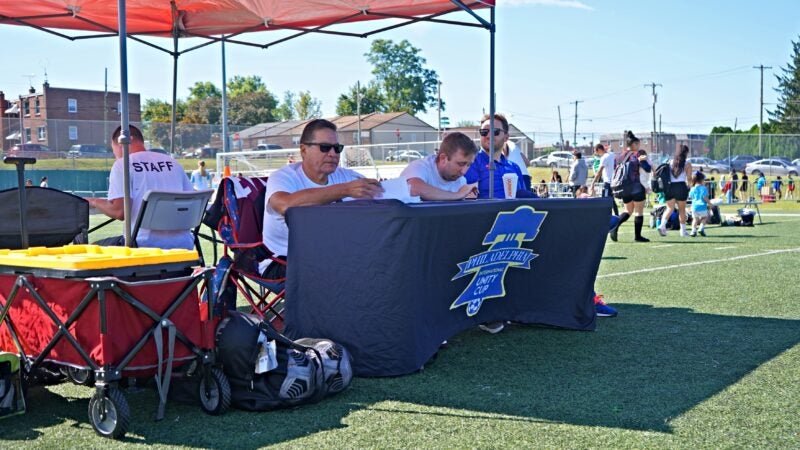 Members of the Unity Cup staff sit at a table