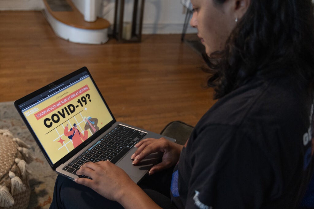 Nilda Diaz looks at her computer screen