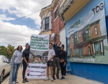 (From left) Tammy Reeves, founder of Resident Action Committee 2; Chef Z, TCG culinary director; Eli Moraru, TCG co-founder and president; Alex Imbot, TCG co-founder and CEO; and Onicah Maynard, also with Resident Action Committee 2, outside the TCG store in the Cobbs Creek section of Philadelphia on Sept. 19, 2023. (Kimberly Paynter/WHYY)