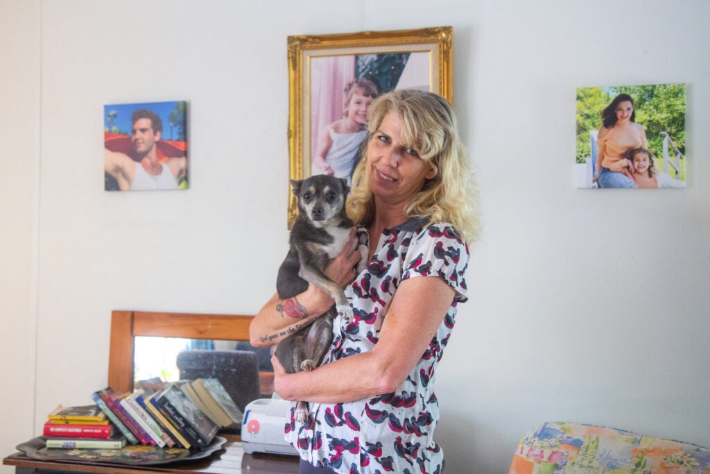 Angie Ellis poses for a photo with her dog, Chick.