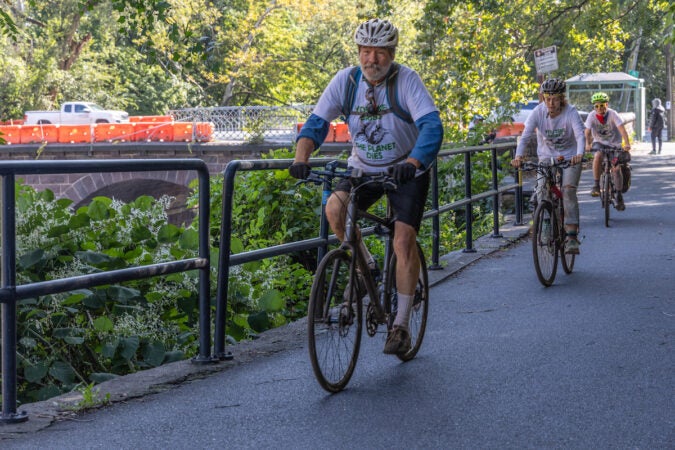 Climate bike riders Ted Glick (left), Shannon Fishkorn (center) and James Jones (right) ride down the Schuylkill River Trail