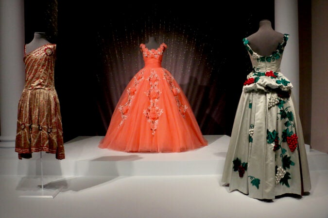 Three dresses are displayed on mannequins