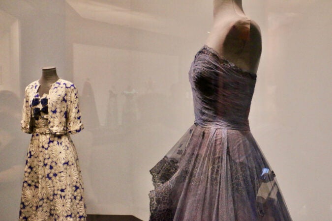 A blue dress in the foreground, and another dress in the background.