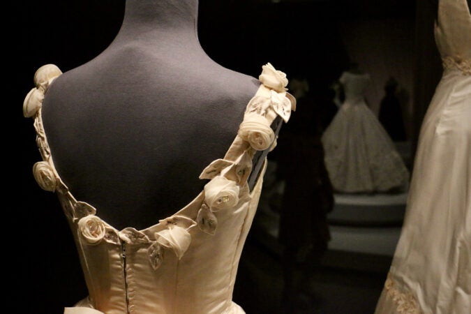 A close-up of handsewn roses and leaves on a dress by Ann Lowe