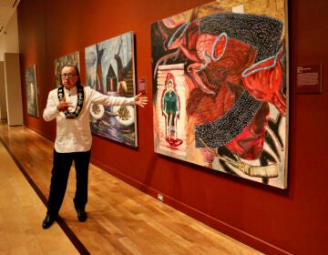 Joe Baker talks about his paintings, one of which depicts his grandmother performing the last Doll Dance in the early 1900s. Baker is one of four artists from the Delaware Tribe of Indians whose work is featured in ''Never Broken: Visualizing Lenape Histories,'' at the Michener Museum