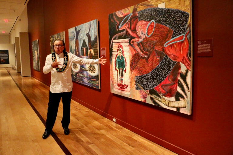 Joe Baker talks about his paintings, one of which depicts his grandmother performing the last Doll Dance in the early 1900s. Baker is one of four artists from the Delaware Tribe of Indians whose work is featured in ''Never Broken: Visualizing Lenape Histories,'' at the Michener Museum