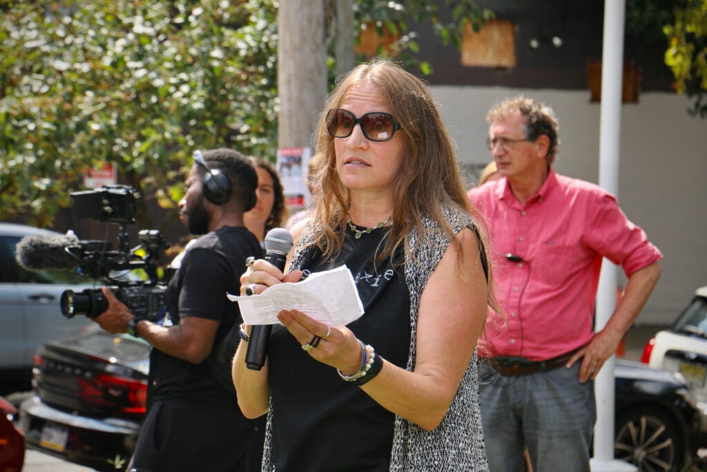 Deb Block speaks into a microphone