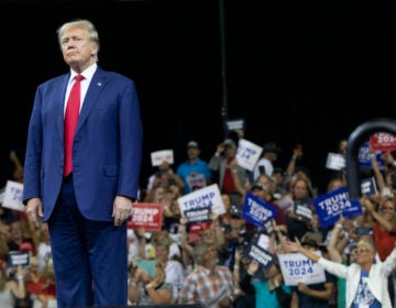 Former President Donald Trump stands as the crowd cheers at the South Dakota Republican Party Monumental Leaders rally Friday, Sept. 8, 2023, in Rapid City, S.D.