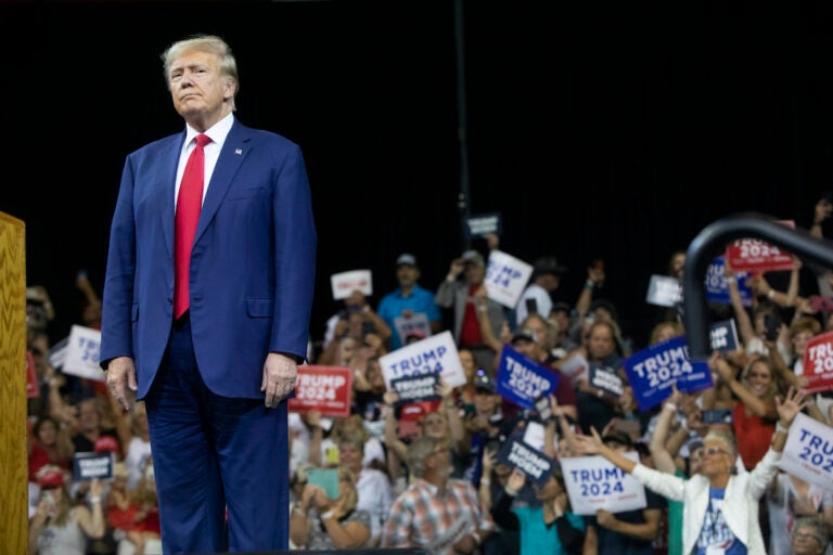 Former President Donald Trump stands as the crowd cheers at the South Dakota Republican Party Monumental Leaders rally Friday, Sept. 8, 2023, in Rapid City, S.D.