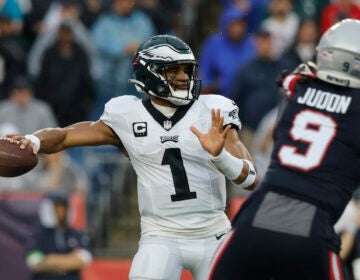Philadelphia Eagles quarterback Jalen Hurts (1) looks for an opening while under pressure from New England Patriots linebacker Matthew Judon (9) in the first half of an NFL football game, Sunday, Sept. 10, 2023, in Foxborough, Mass