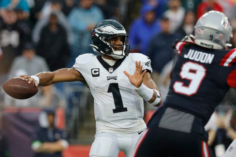 Philadelphia Eagles quarterback Jalen Hurts (1) looks for an opening while under pressure from New England Patriots linebacker Matthew Judon (9) in the first half of an NFL football game, Sunday, Sept. 10, 2023, in Foxborough, Mass