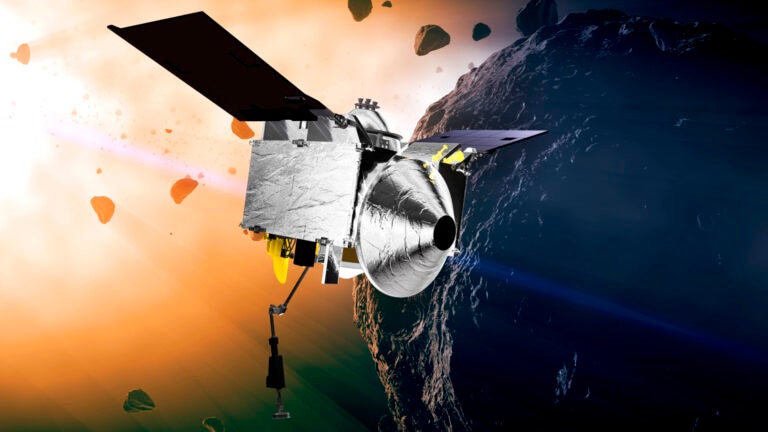 This illustration provided by NASA depicts the OSIRIS-REx spacecraft at the asteroid Bennu. On Sunday, Sept. 24, 2023, the spacecraft will fly by Earth and drop off what is expected to be at least a cupful of rubble it grabbed from the asteroid Bennu, closing out a seven-year quest.